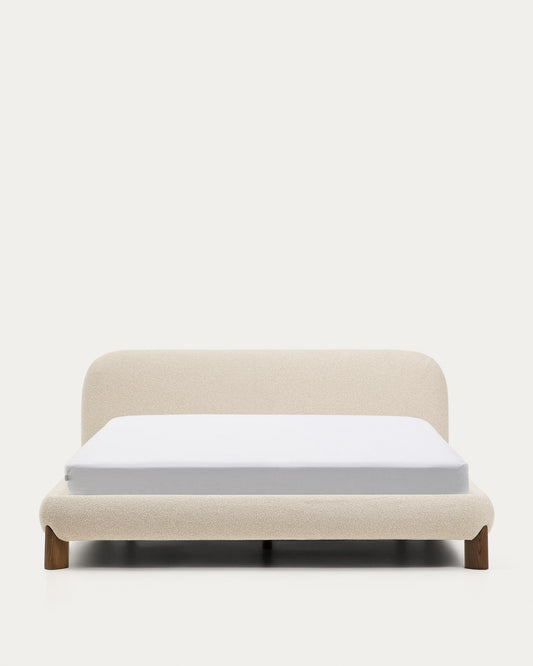 Llit desenfundable Odina bouclé cru i potes de fusta massissa de freixe amb acabat en to noguera per a matalàs de 180x200 cm