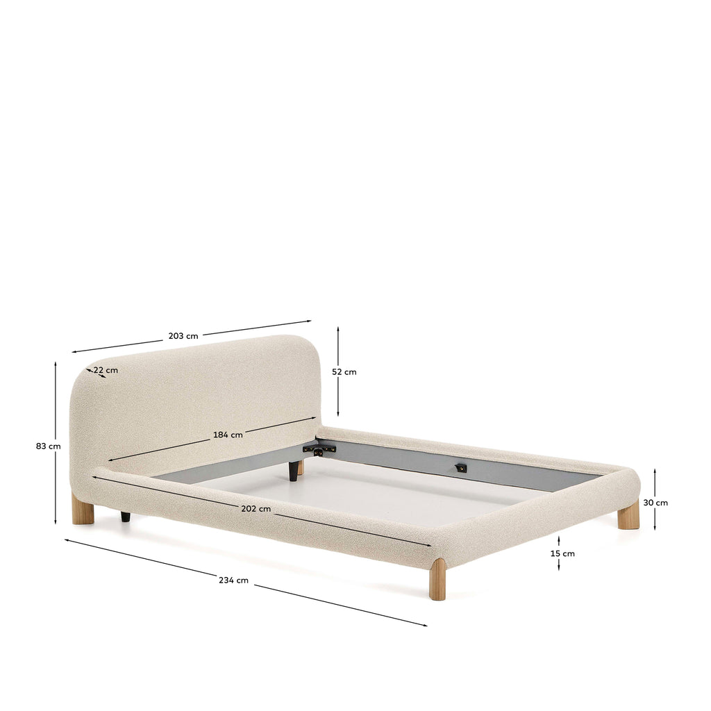 Llit desenfundable Odina bouclé cru i potes de fusta massissa de freixe amb acabat en to natural per a matalàs de 180x200 cm